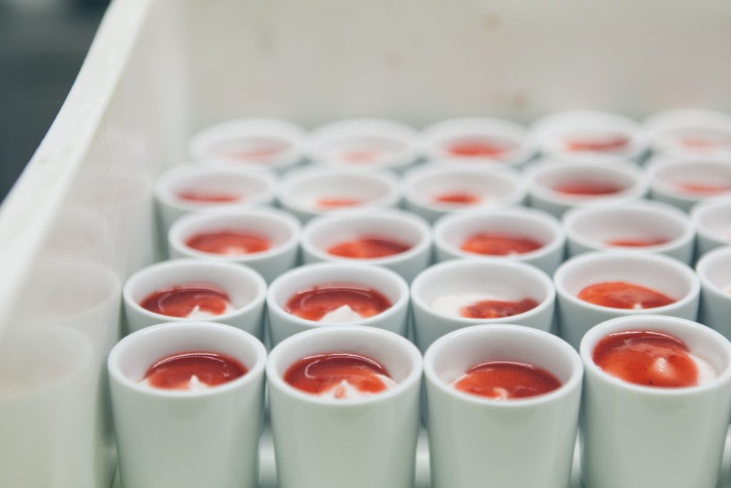 a bunch of cups filled with red liquid